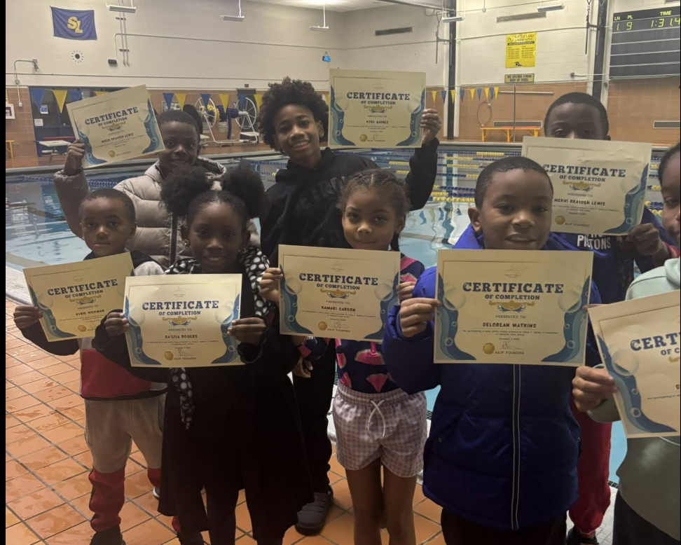Children proudly holding certificates of completion after finishing the foundation's swim class